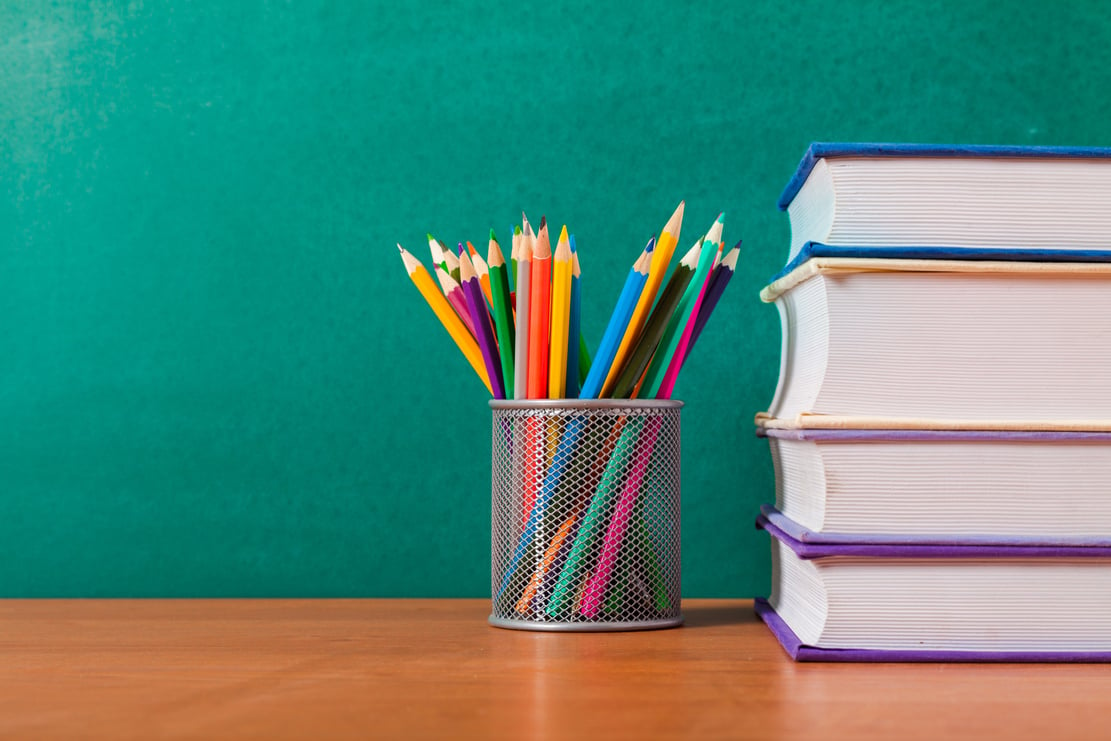 Colored Pencils and a Stack of Books